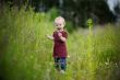 Smiling little baby in a meadow