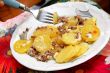 Baked potatoes with meat in plate