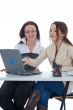 Two business woman work with laptop