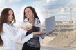 Two business woman advertises real estate