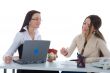 Two business woman advertises real estate on white