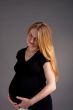 smiling young pregnant blonde in dark shirt