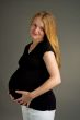 smiling young pregnant blonde in dark shirt