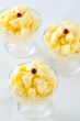 Three pineapple desserts decorated with cranberry