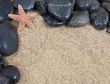 zen spa river rocks on sand in form of border