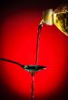 pouring oil on spoon