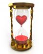 Golden hourglass with heart and blood 