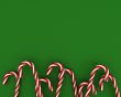 Christmas candies on green background