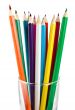 A glass cup with pencils