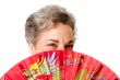 Senior woman with red dragon fan