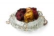 Crystal vase with the dried roses and costume jewellery. Isolate
