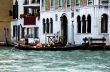 Venetian gondola and gondolier at the main canal of Venice. Ital