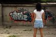 The beautiful girl against graffiti. 