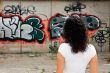 The beautiful girl against graffiti. 