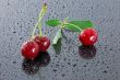 Three wet red cherries.