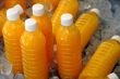 Bottles of Fresh Orange Juice on Ice