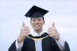 Happy asian graduate thumbs up