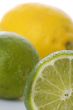 Lime and lemon on white macro