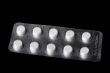 Medical tablet on black