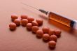 Red Tablet and syringe on red