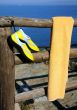 Towel and Beach Shoes on Wooden Fence