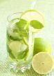 Mojito cocktail on green background