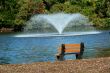 Fountain on a pond with bench