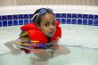 A young boy soaking in a hot tub