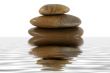 Stack of zen rocks with water reflection