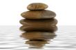 Stack of zen rocks with water reflection