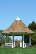 White gazebo in a park with blue sky