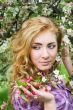 Red-headed woman under cherry tree