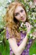 Red-headed woman under cherry tree