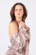 The thoughtful girl in a silvery dressing gown