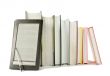 Row of printed books with electronic book reader
