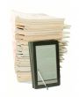 Ebook with a stack of old newspapers behind