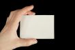 Hand holding a white card