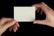 Hands holding a white card