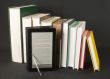 Row of printed books with electronic book reader 