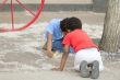 Two young boys looking at flower seed heads