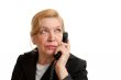 Senior Woman talking on the phone in black suite.