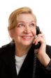 Senior Woman talking on the phone in black suite.