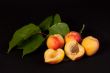 Ripe apricots on black background