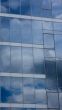 Sky and clouds reflected in modern window