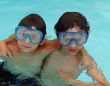 two boys with goggles in swimming pool
