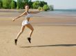 Young woman running alone on the beach