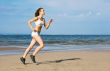 Young woman running alone on the beach