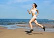Young woman running alone on the beach