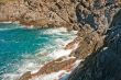 Storm waves roll and break on rocks