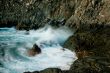 waves roll over the rocks